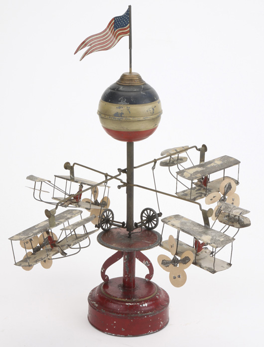 Muller & Kadeder clockwork carrousel with Wright Brothers-style airplanes, $14,950. Noel Barrett Auctions image.